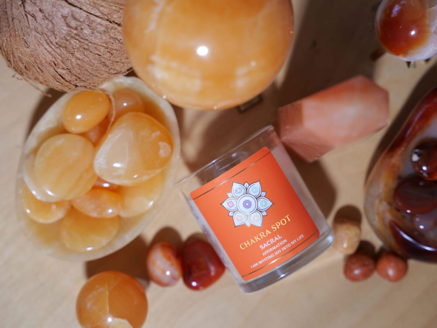 Chakra candle with orange stones and decor.